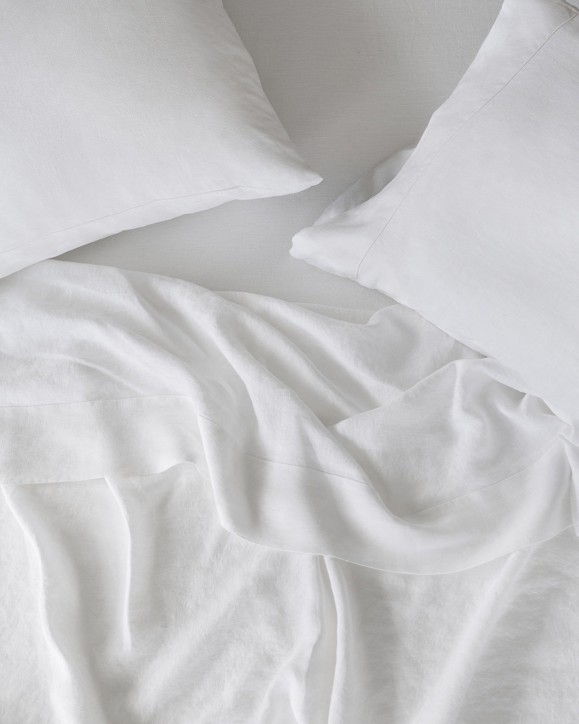 The view from above of white linen sheets and two pillows. [39418737524920, 39418737557688, 39418737590456, 45933184057563,46509672988891,40166756876472,40166758777016,40166759792824,40166633799864,40166633832632,40166633865400]